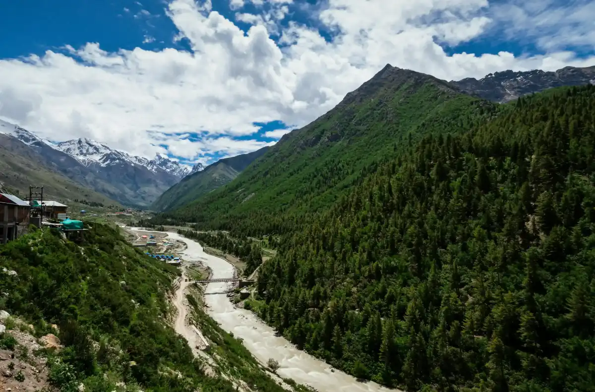 A high-altitude landscape of Spiti Valley with winding roads and mountains